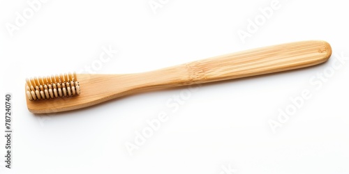 A wooden toothbrush rests gracefully on a pristine white background