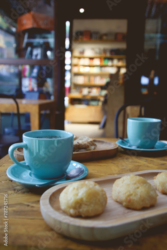 cups of coffee on a coffee shop table with bookstore shelves in the background