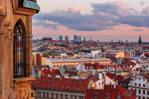 The cityscape of UNESCO site Prague and the V tower on Pankrac and the Old Town Hall in sunset.  photo