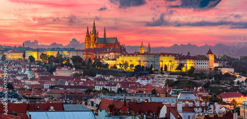 The aerial view of UNESCO site Prague cityscape of downtown and the illuminated castle and the St. Vitus Cathedral in colorful twilight.