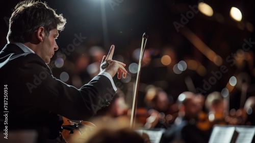 A conductor directs the orchestra with expressive hand gestures and focused facial expressions during a concert performance
