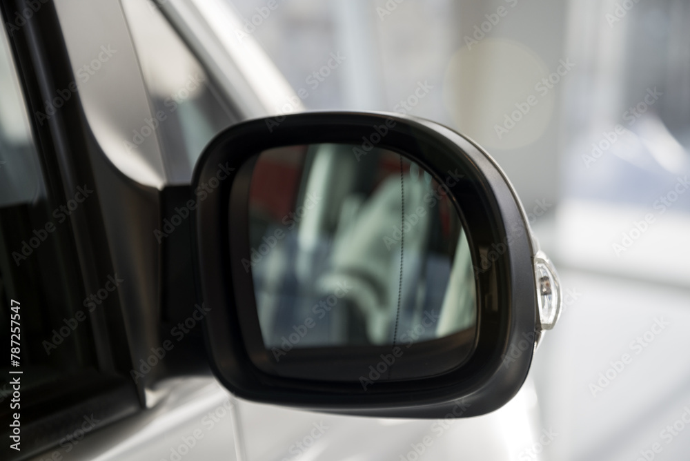 look in the rear view mirror of a grey car