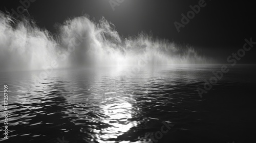 Mysterious black and white landscape with mist rising above calm, dark waters, evoking themes of solitude and introspection. Copy space.