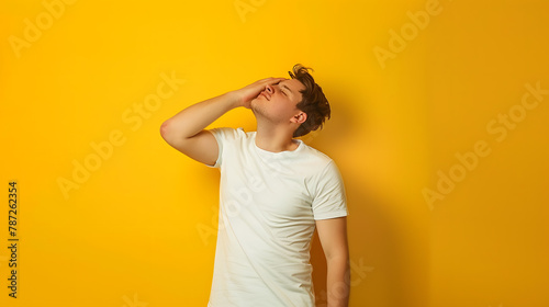 Full length photo of minded man hand touch head eyes closed lost money bankrupt stand empty space isolated on yellow color background : Generative AI photo