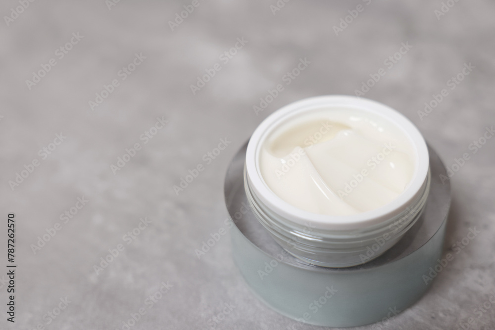 Body cream on grey table, closeup. Space for text Body cream on grey table, closeup. Space for text