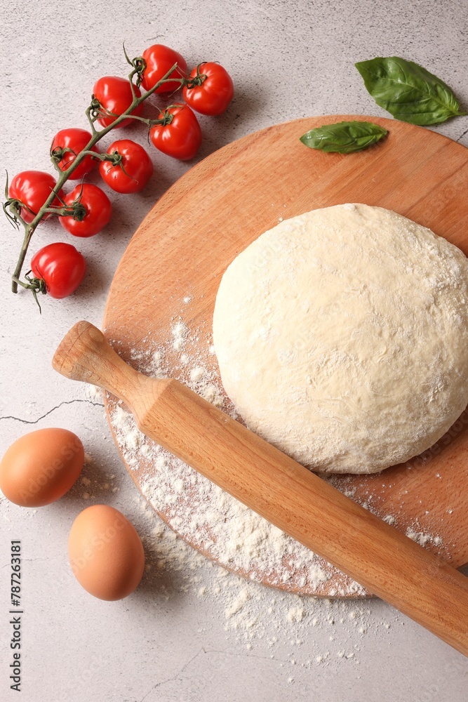 Pizza dough, products and rolling pin on gray textured table, flat lay Pizza dough, products and rolling pin on gray textured table, flat lay