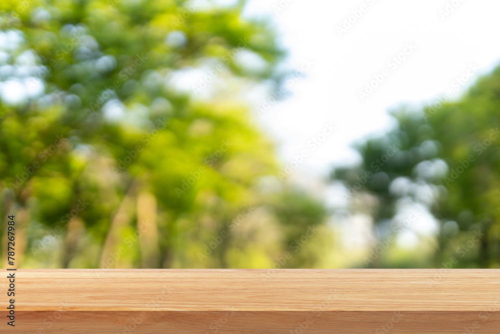 Wooden table top on blur nature bokeh green park background. Empty Wooden tabletop used for advertising products or products Wooden table top on blur nature bokeh green park background. Empty Wooden tabletop used for advertising products or products