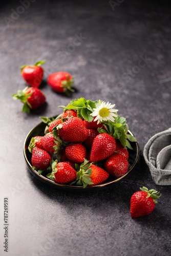Red ripe strawberries berries. Dark background