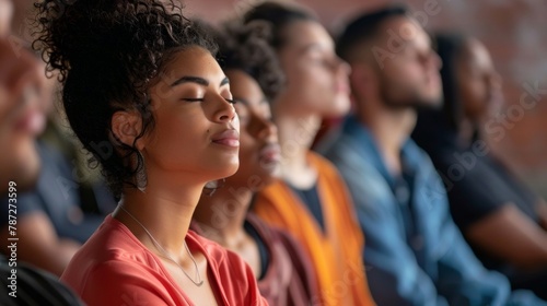 A group of people sitting in a circle with their eyes closed participating in a guided meditation using bioacoustic sound therapy. . photo