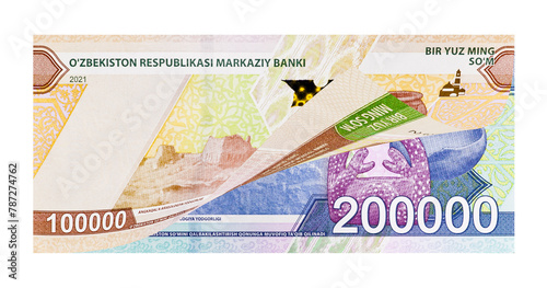 Uzbek one and two hundred-thousand banknotes as a concept of increasing the value of national currency. Image isolated on white background