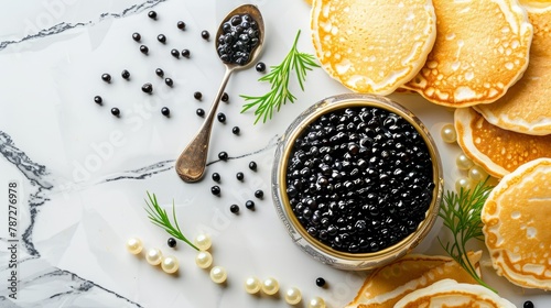 Black caviar with a spoon and snacks, mini pancakes photo