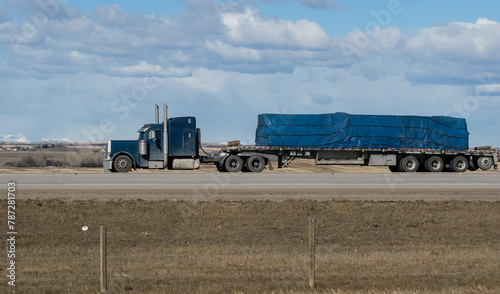Heavy cargo on the road. A truck hauling freight along a highway. Taken in Canada