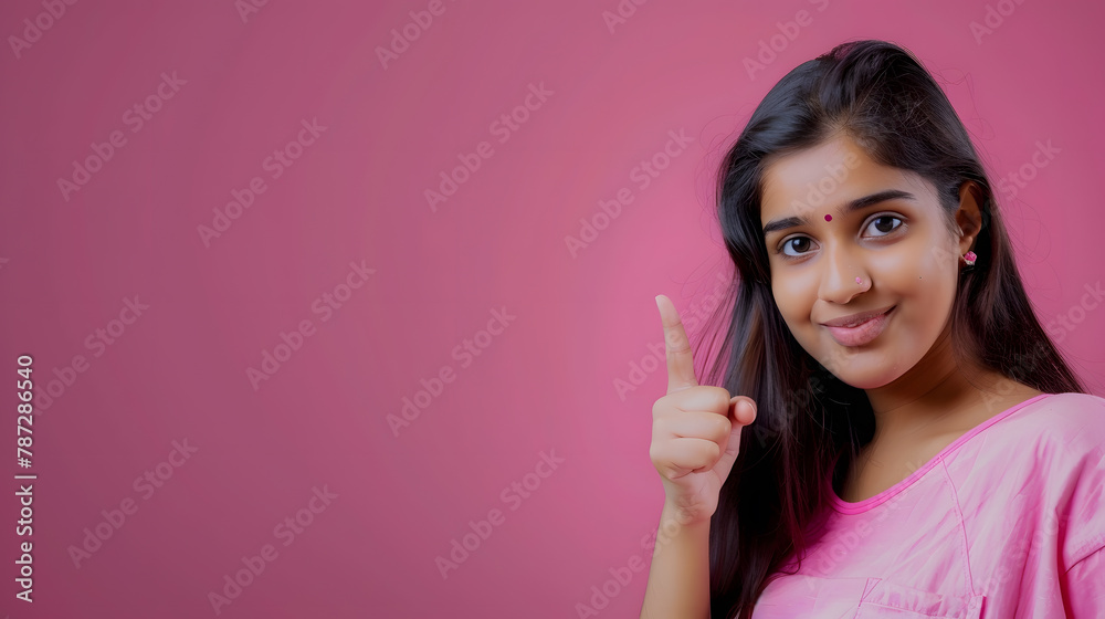 Happy young Indian girl looking at camera pointing at copy space standing isolated by studio background Female customer advertising shopping sale discount promo Head shot portrait : Generative AI Happy young Indian girl looking at camera pointing at copy space standing isolated by studio background Female customer advertising shopping sale discount promo Head shot portrait : Generative AI