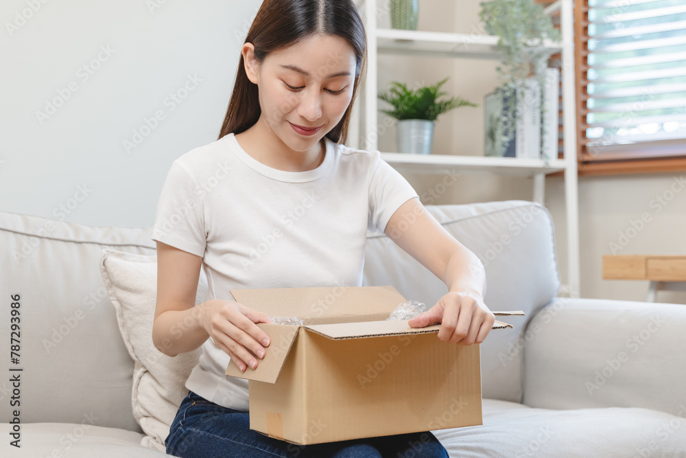 person unboxing package shopping online via internet at home person unboxing package shopping online via internet at home
