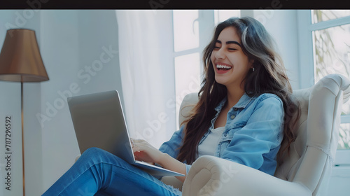 Happy pretty young longhaired arab woman in casual outfit sitting in armchair over white wall background typing on pc laptop keyboard and smiling female digital nomad working from home : Generative AI photo