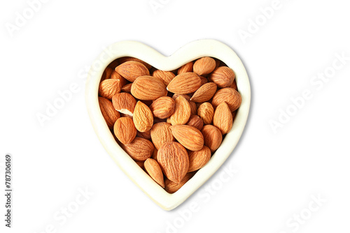 bitter almond dry fruit also known in india as kadvi badam,kadwa badam,isolated in heart shape bowl,cutout in transparent background,png format,top view  