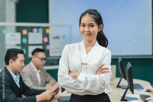 Happy confident smiling young professional Asian business woman corporate leader, Japanese female employee or company sales marketing manager standing arms crossed in office, cute girl portrait