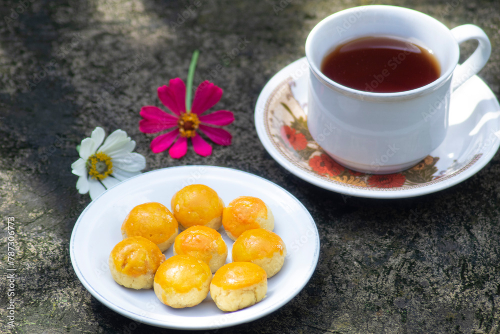 cheese cake with tea and flowers beside cheese cake with tea and flowers beside