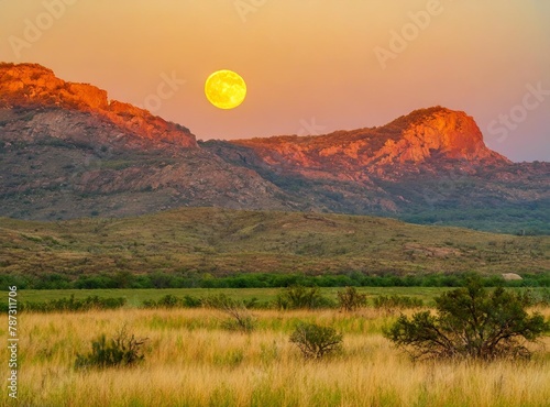 Sunset landscape with a full moon in Wichita Mountains National Wildlife.