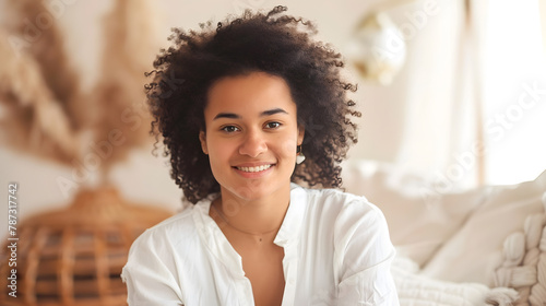 Young biracial woman poses casually in a bright home setting with copy space her cheerful demeanour adds a welcoming touch to the modern interior : Generative AI