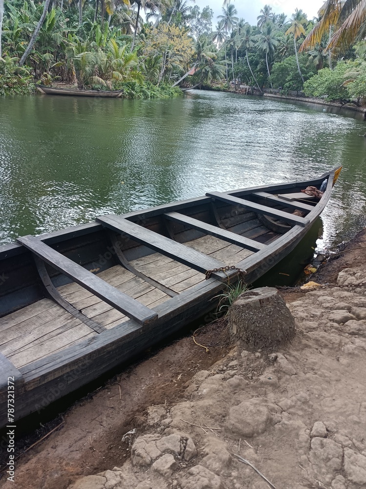 Obraz premium A canoe is a lightweight narrow water vessel, typically pointed at both ends and open on top, propelled by one or more seated or kneeling paddlers facing the direction of travel and using paddles.