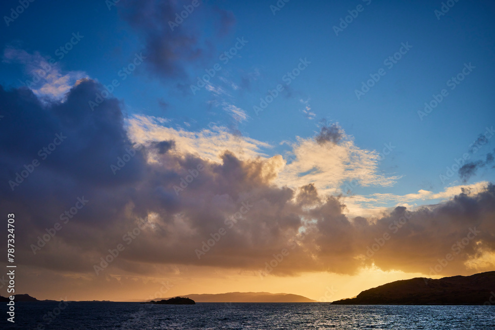Fototapeta premium West from Craobh Haven, The sun starts to sink low as dusk begins to take shape. Craobh Haven, Argyll and Bute, Scotland