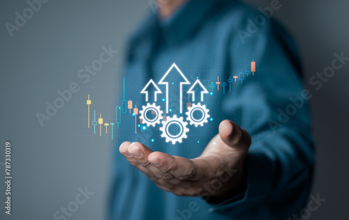Process to increase productivity concept. Businessman holding productivity icon with growth graph for industrial management in efficiency and efficient process. Lean cost and productivity growth.