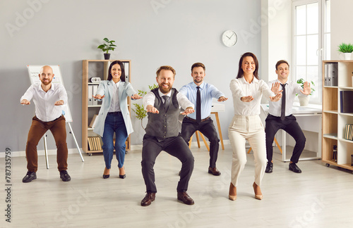 Team of businesspeople is exercising and stretching with smiles and in good mood during a work break. Health and teamwork, highlighting the importance of physical activity even during work hours.