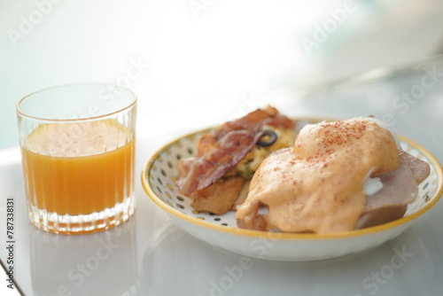Hamburger and sesame dressing breakfast with orange juice on table