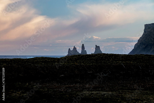landscape of Reynisdrangar rock stack in ocean in Vik, Iceland 
