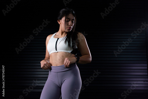 sporty portrait of a young female athlete posing, with copy space