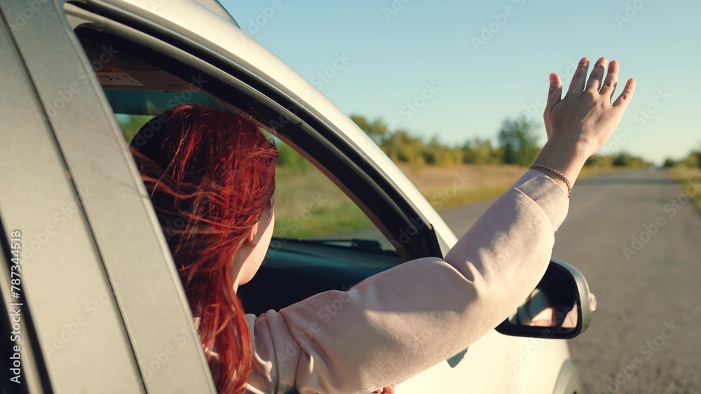 girl rides car with her hand out window, beautiful young woman smiling sunset, hand moving wind, happy family, cheerful girl looking out open car window, people travel, adventure lifestyle, curly hair - obrazy, fototapety, plakaty 