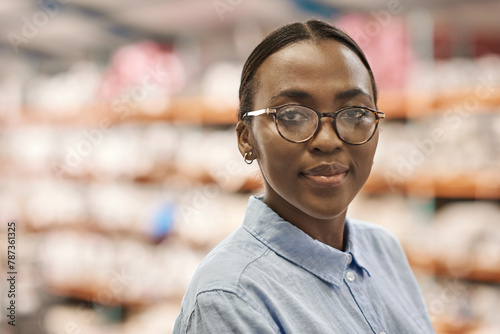 Confident young African woman standing in a large warehouse