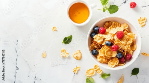 Delicious american breakfast  cornflakes, berries, honey on white background with copy space photo