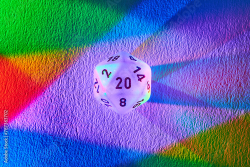 Colorful D20 Die on Rainbow Spectrum Background, Macro Perspective