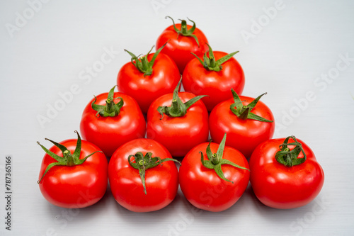 Food triangle, Red ripe tasty Dutch tomatoes, vegetables background top view close up copy space © barmalini