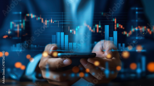 Businessman using a smartphone with digital charts and stock graphs projected on smartphone shows trends and data for business over global network connection. 