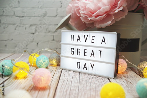 Have a Great Day text on lightbox on wooden background