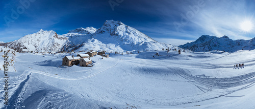 The Simplon Pass, snowy with the peaks of the Lepontine Alps and the small village of 