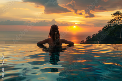 A woman relishing a sunset view from an infinity pool, a symbol of a luxurious and opulent lifestyle