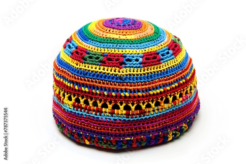 A colorful crocheted kufi hat featuring traditional African patterns and vibrant colors, often worn in many West African cultures, isolated white background