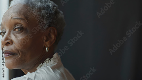 Portrait of a beautiful elderly 70yearold AfricanAmerican grandma spokesperson looking back over shoulder with ad or copy space for your ad : Generative AI photo