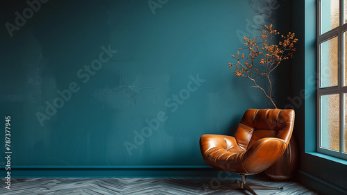 Living room with a leather chair opposite an empty dark blue wall.