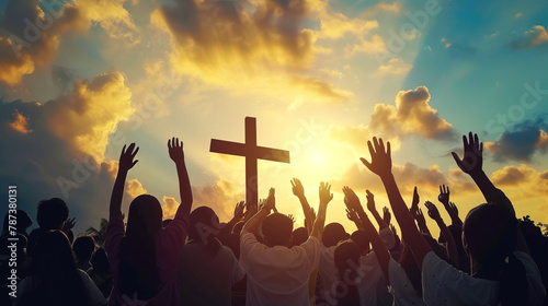 Christians with hands raised in praise  worship and prayer to God at sunrise