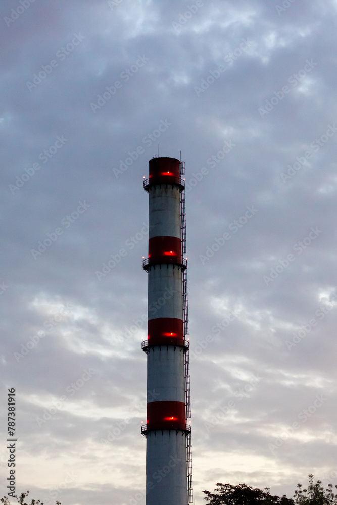 Brick chimney of factory on background of blue sky
