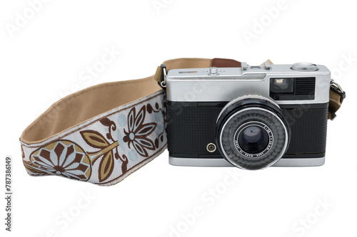 Detail of an old compact photo camera with a nice strap on a white background. It is a travel camera that comes with 35mm film.