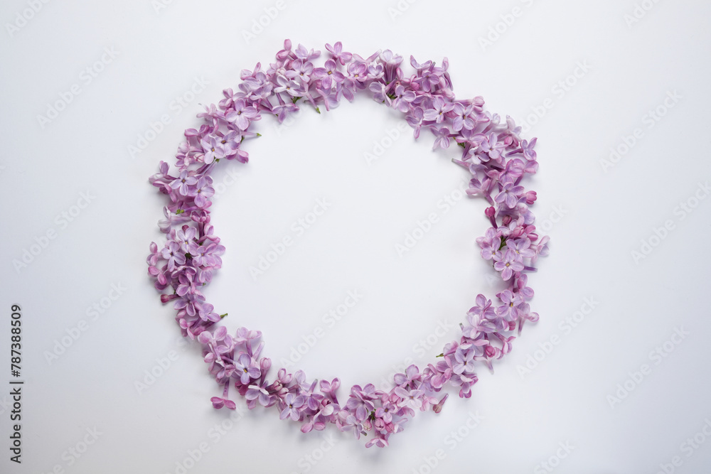 Round frame of lilac flowers isolated on a white background. Top view, flat lay. Space for text. Round frame of lilac flowers isolated on a white background. Top view, flat lay. Space for text.