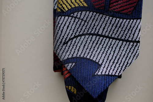 Classic tie fabric texture close-up with abstract pattern on a gray background