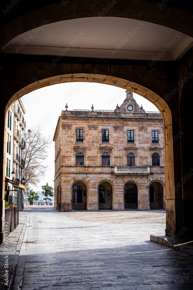 In Gijón's deserted urban setting, an architectural arch offers a window to its soul.