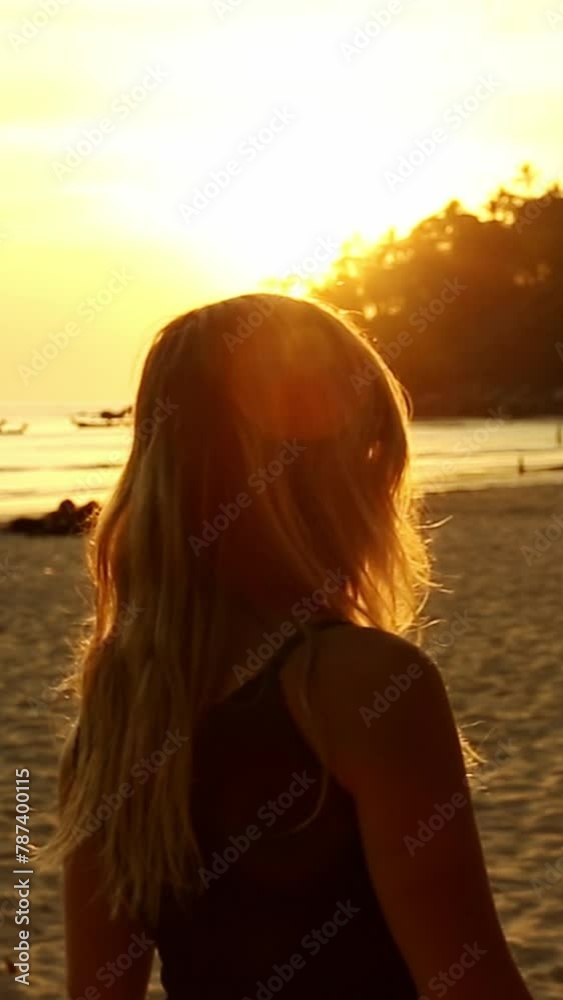 Portrait of young woman with sunglasses in sunshine on background of sea or ocean beach in summer evening at sunset. Travel, vacation, holiday, tourism Portrait of young woman with sunglasses in sunshine on background of sea or ocean beach in summer evening at sunset. Travel, vacation, holiday, tourism